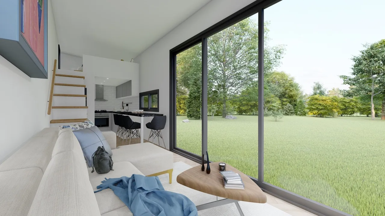 Inside a finished tiny home: open living and kitchen with a full-height glass wall